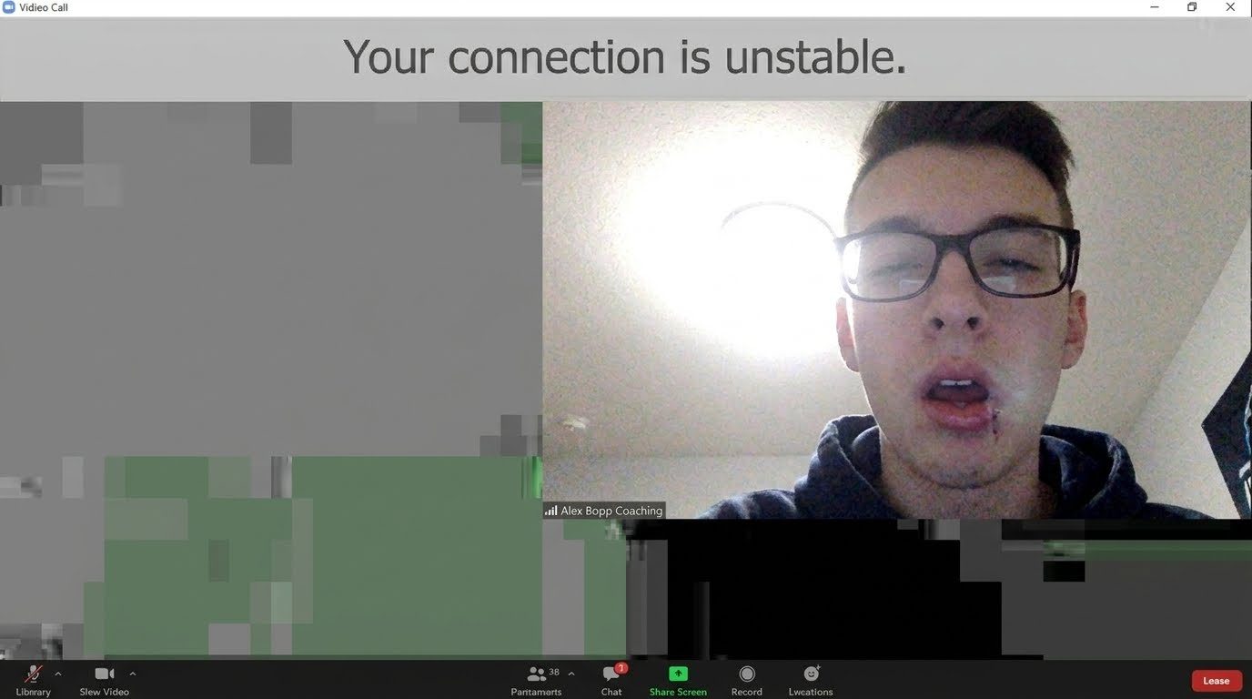 A laggy, pixelated video call frozen on Alex mid-blink